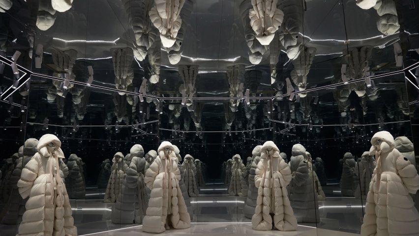 White puffer jacket design repeated in mirrored installation