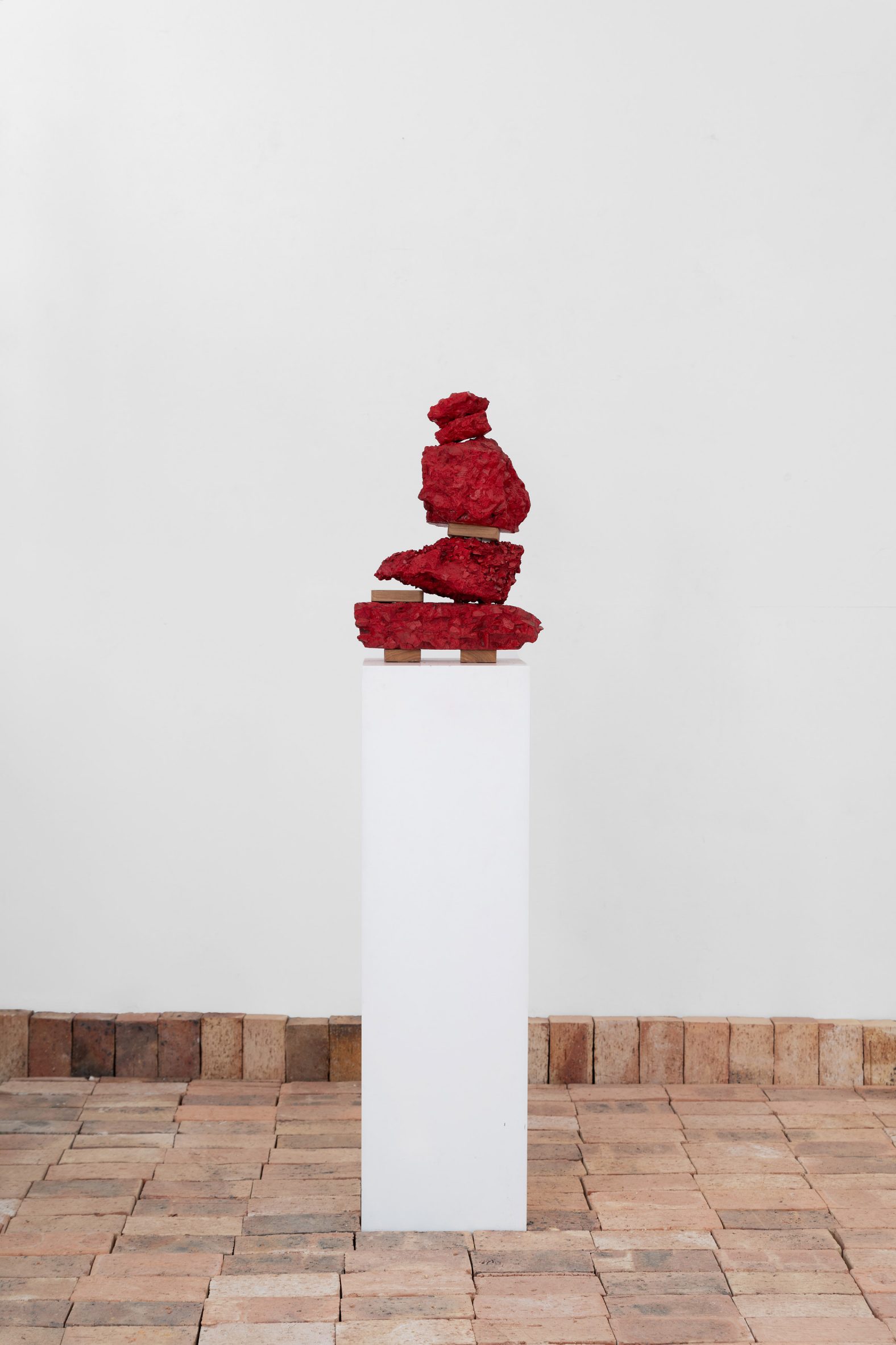 Photo of a red found object sculpture by Kent Andreasen