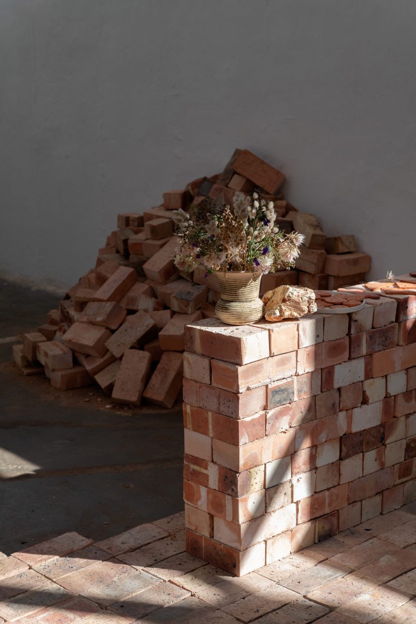 Photo of a stack of bricks and a low wall in the Clay, Library, Land Studies exhibition