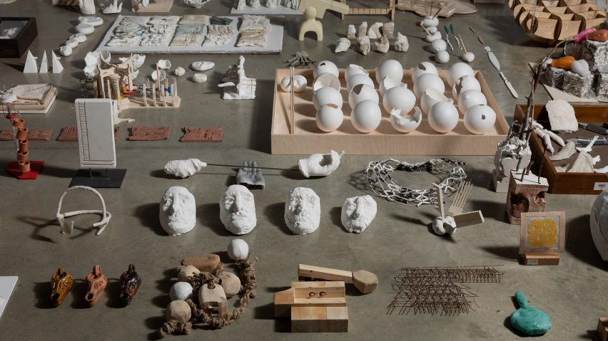 A photograph of multiple archival museum artefacts laid out on a grey surface.