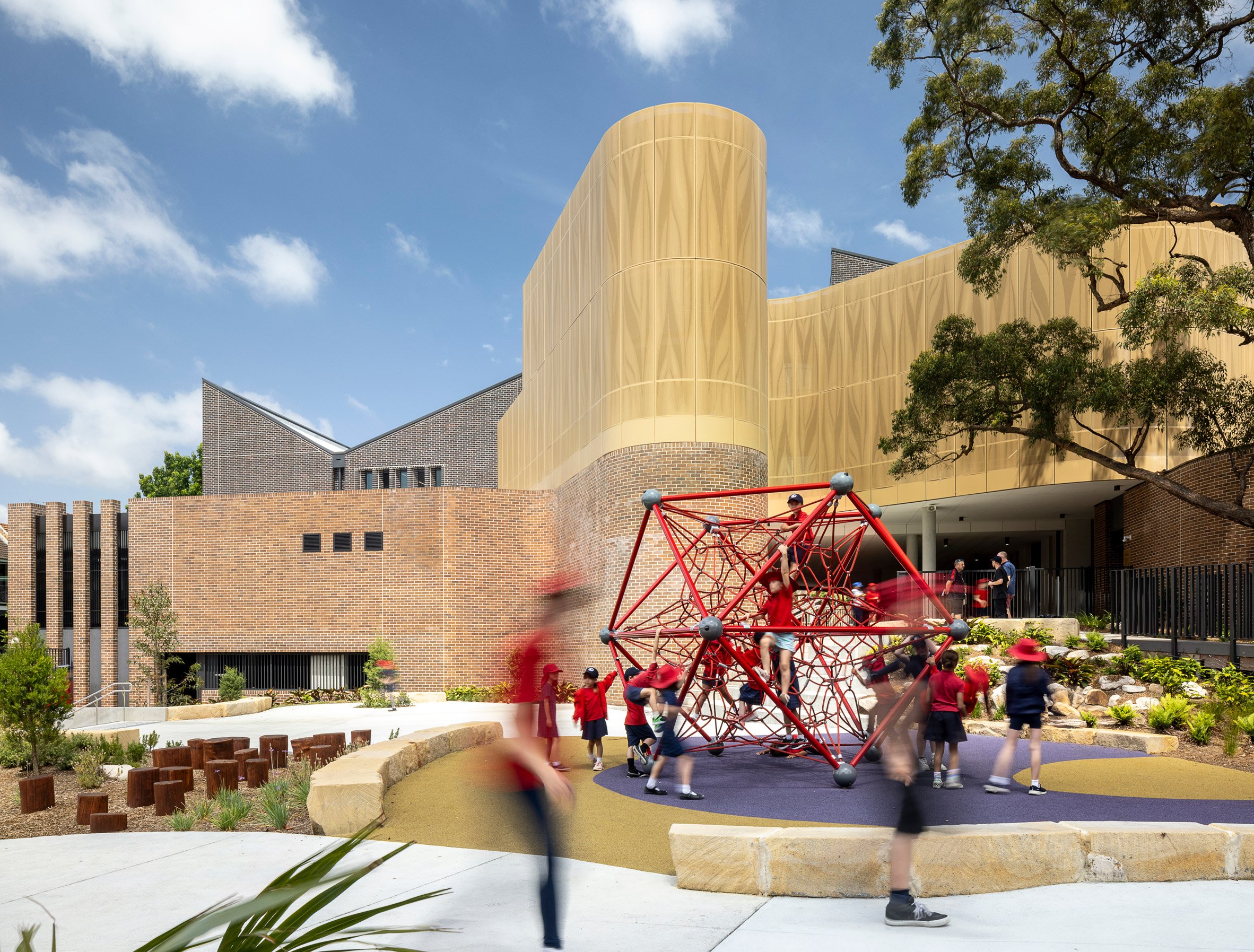 Outdoor play area at community school by Fjcstudio