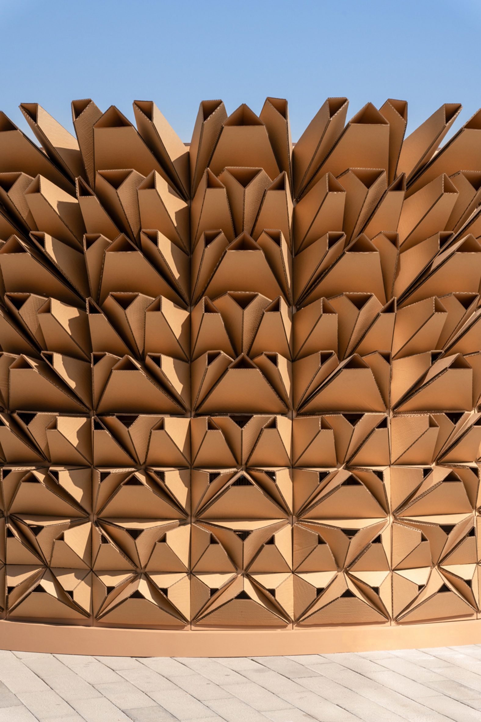 Cardboard modules surrounding a pavilion by Deond