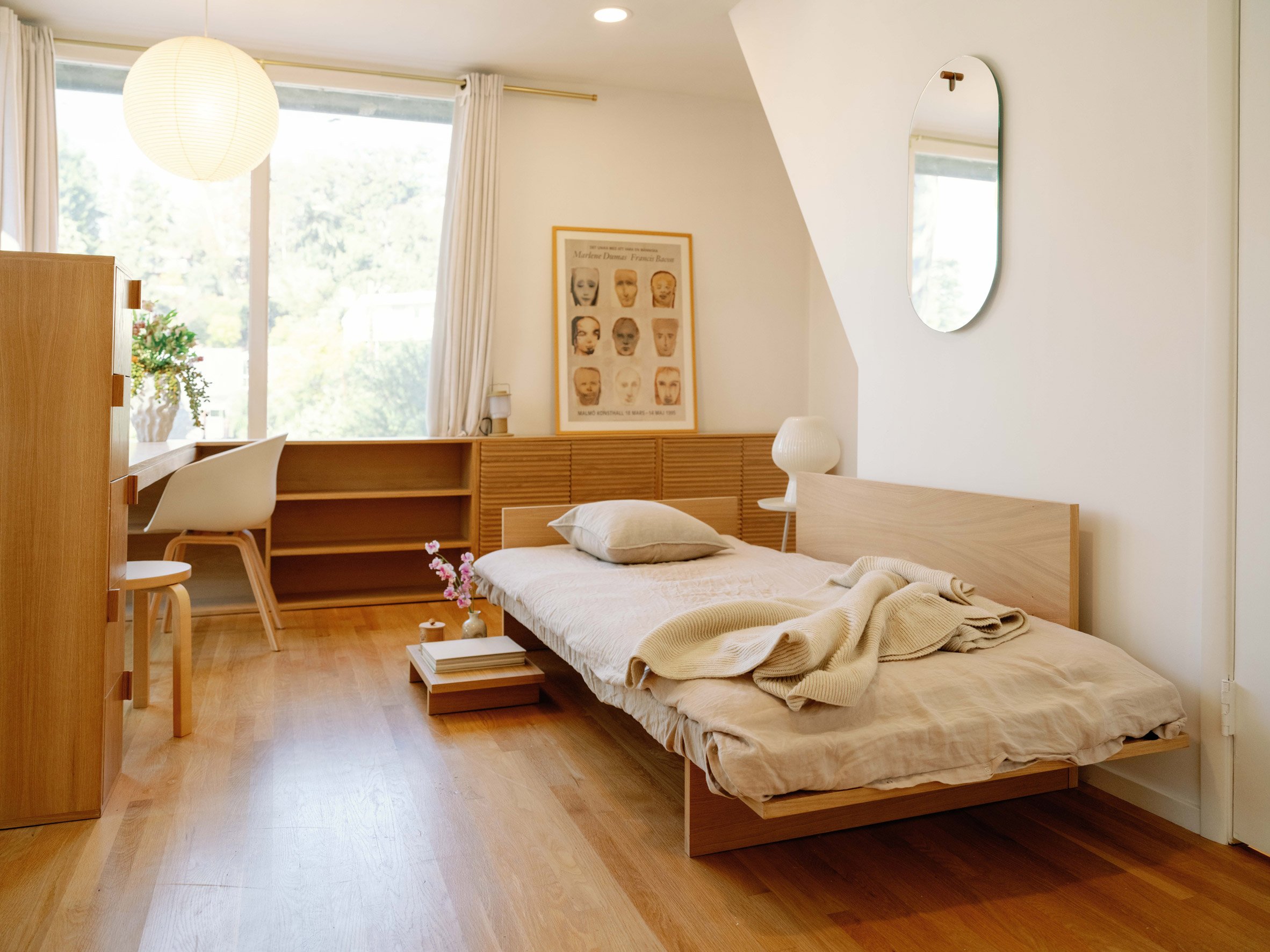 Bedroom with wooden furniture, white floors and linen fabrics