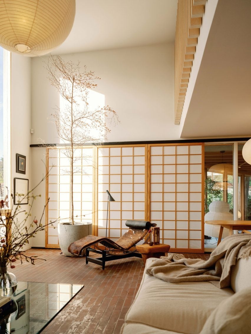 Living room with shoji screens and a Le Corbusier LC4 chair