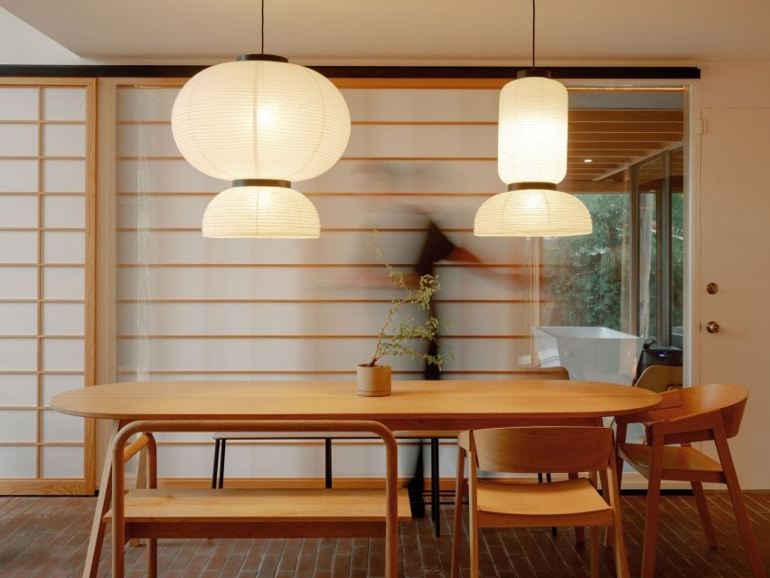 Akari lamps suspended above a wooden dining table