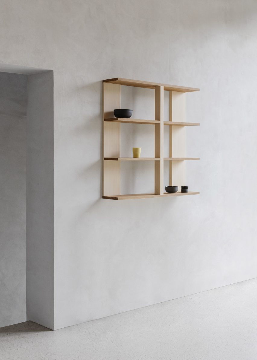 Wooden shelf mounted onto white wall