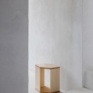 Wooden side table in white-walled interior