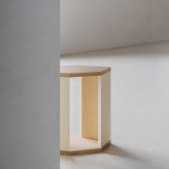 Wooden side table in white-walled interior