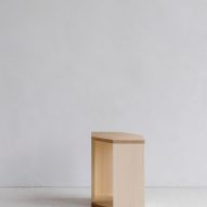 Wooden side table in white-walled interior