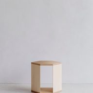 Wooden side table in white-walled interior