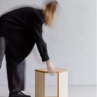 Person picking up wooden side table