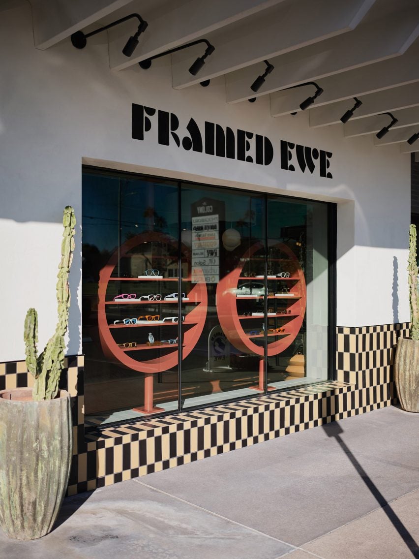 Store window with a pair of circular shelving displays that resemble eyewear frames