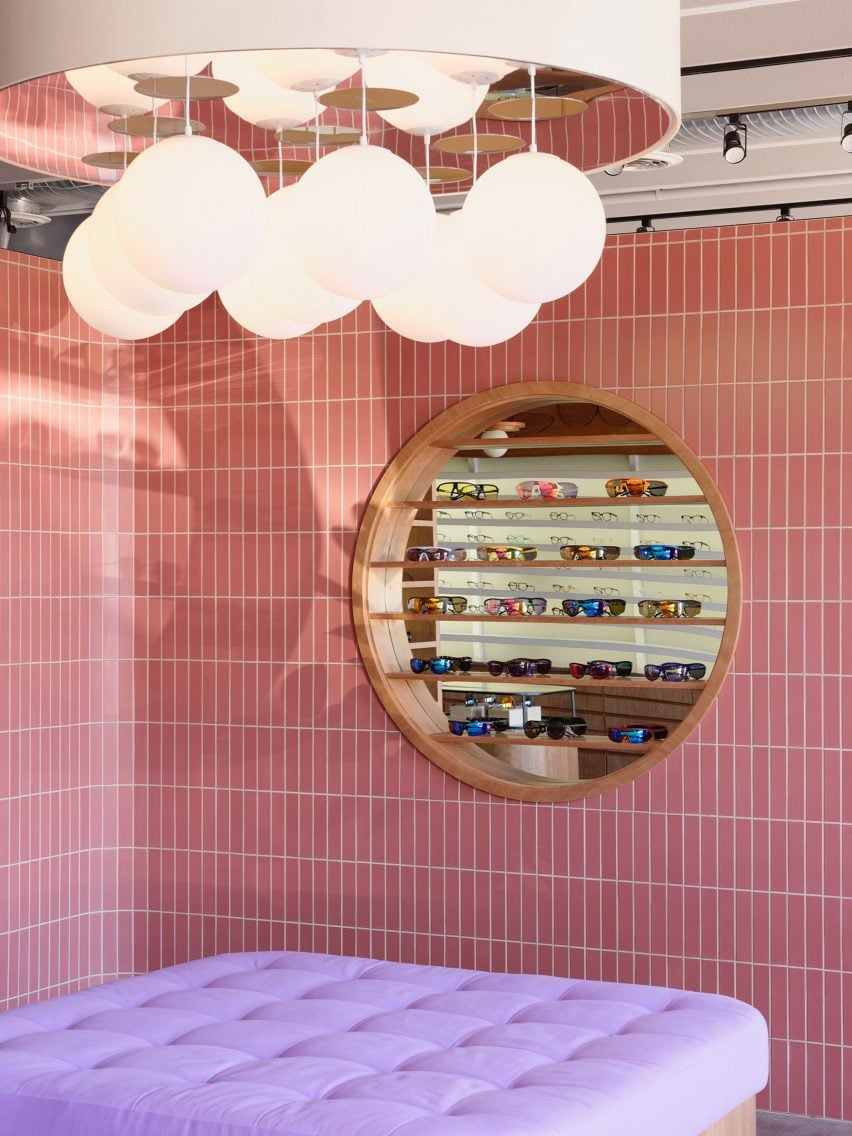 Waiting area with pink wall tiles and a purple seat