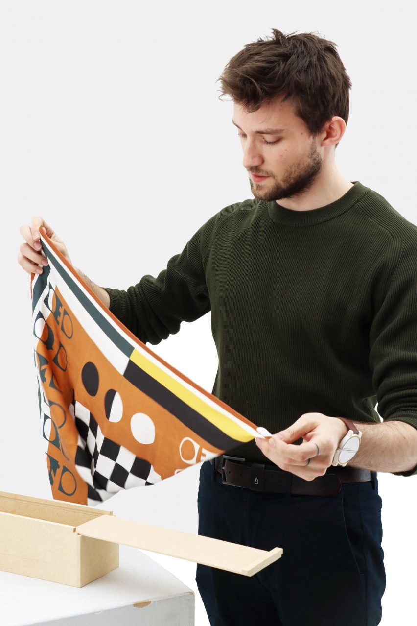 Photo of Louis Le Joly Senoville folding his Ha Mat silk chessboard in two