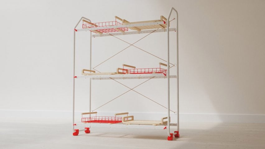 A photograph of a shelving system on wheels, in tones of white and red, against a pale grey backdrop.