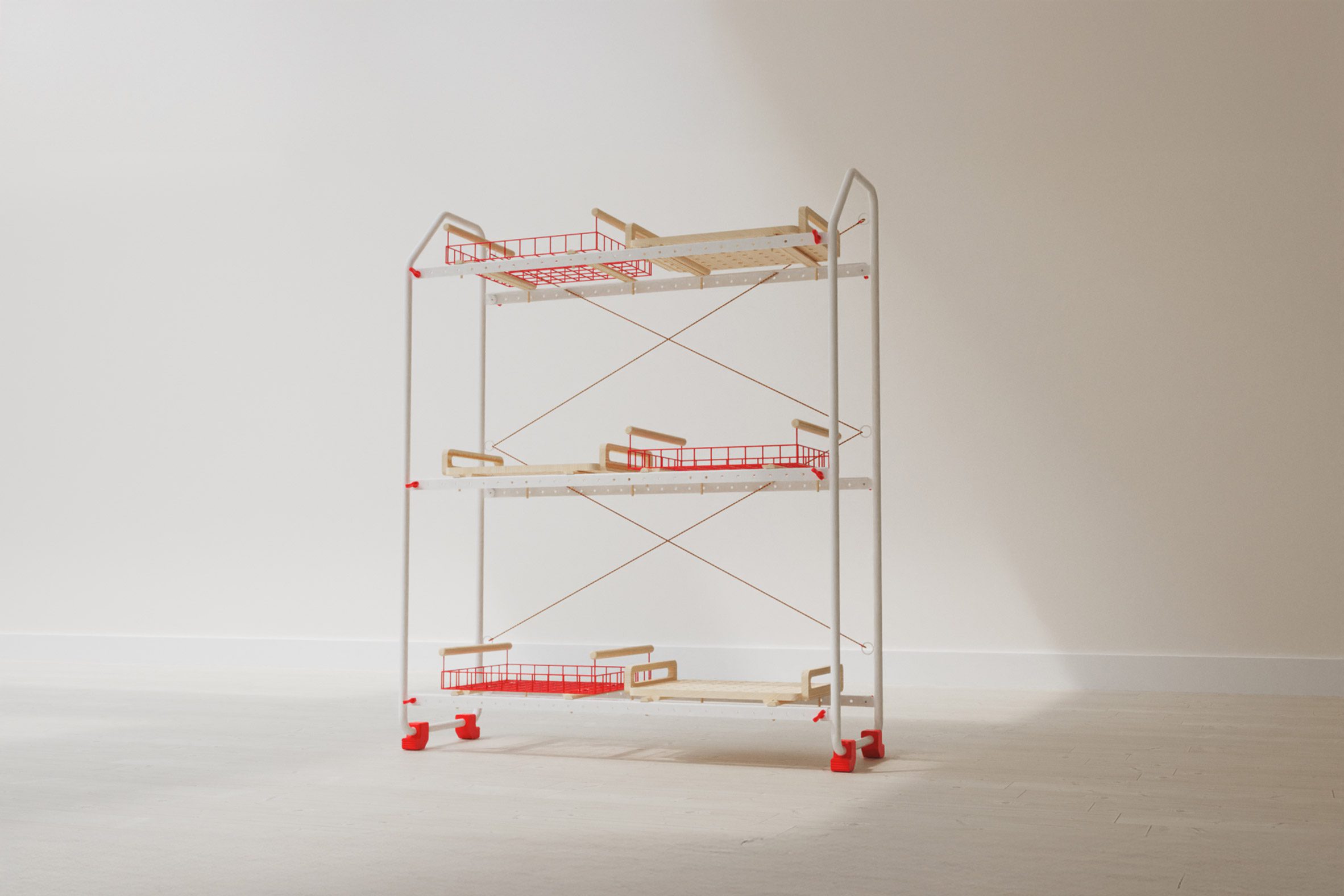 A photograph of a shelving system on wheels, in tones of white and red, against a pale grey backdrop.