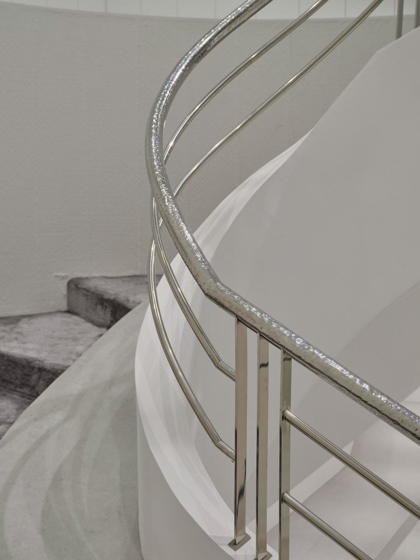 Hammered metal handrail of staircase in IZA Tokyo boutique