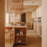 Hidden bookcase-door conceals rooms in minimalist Barcelona apartment