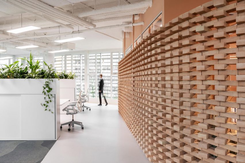 Curved brick wall inside workspace designed by Firm Architects 