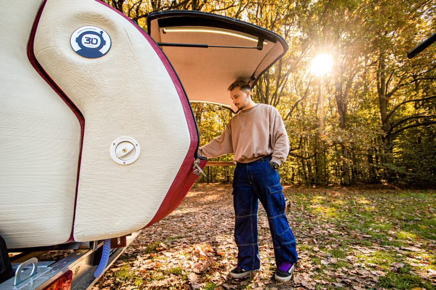 Man opening 3D-printed Tiny Camper by Lemki Robotix