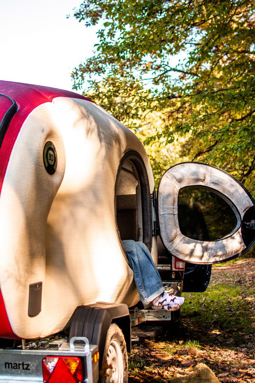Legs dangling out of a camper