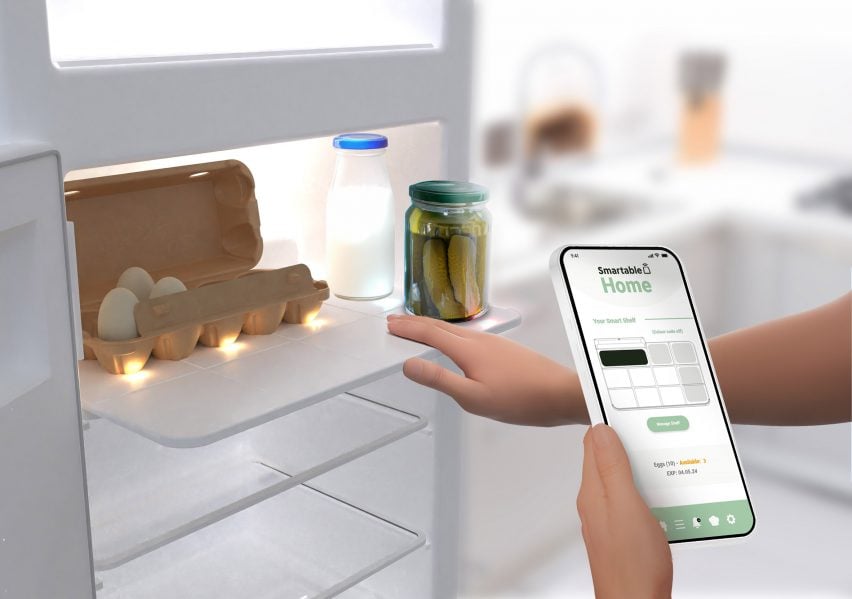 Someone looking in a fridge and using a smartphone app