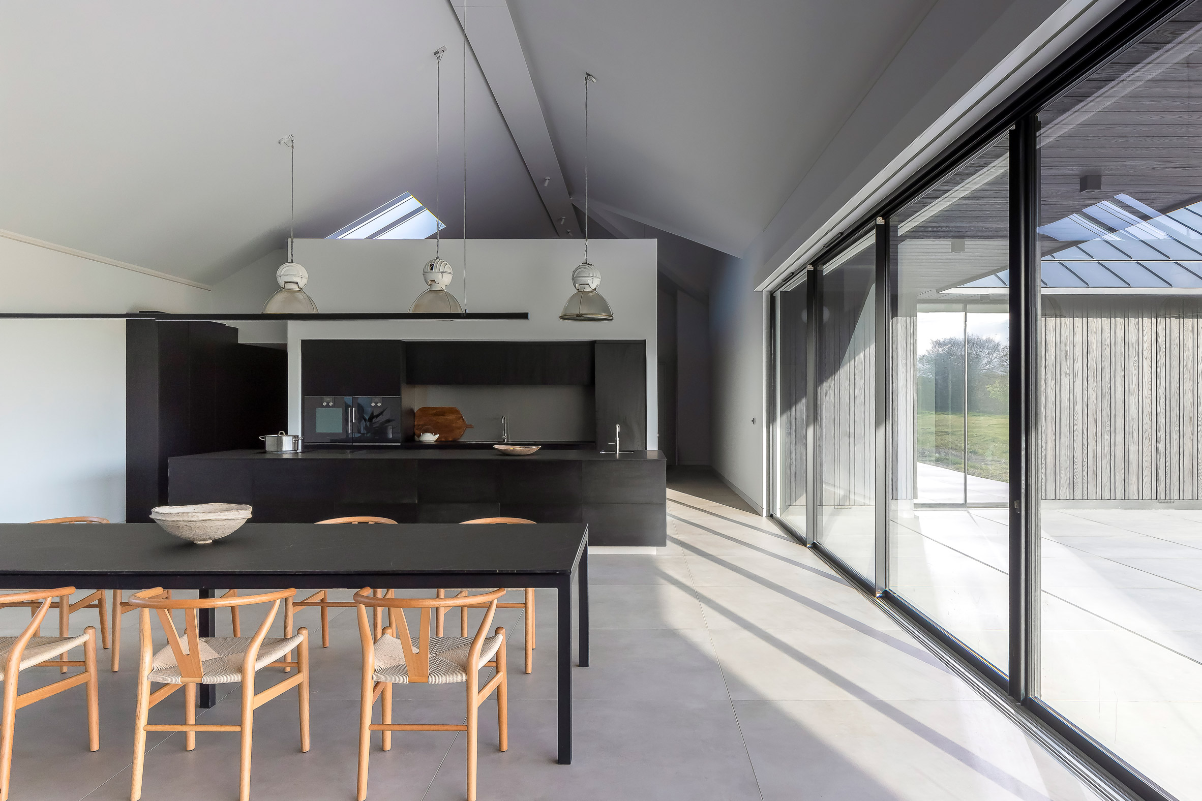 Kitchen and dining room within home by Mailen Design and Peter Bradford Architects