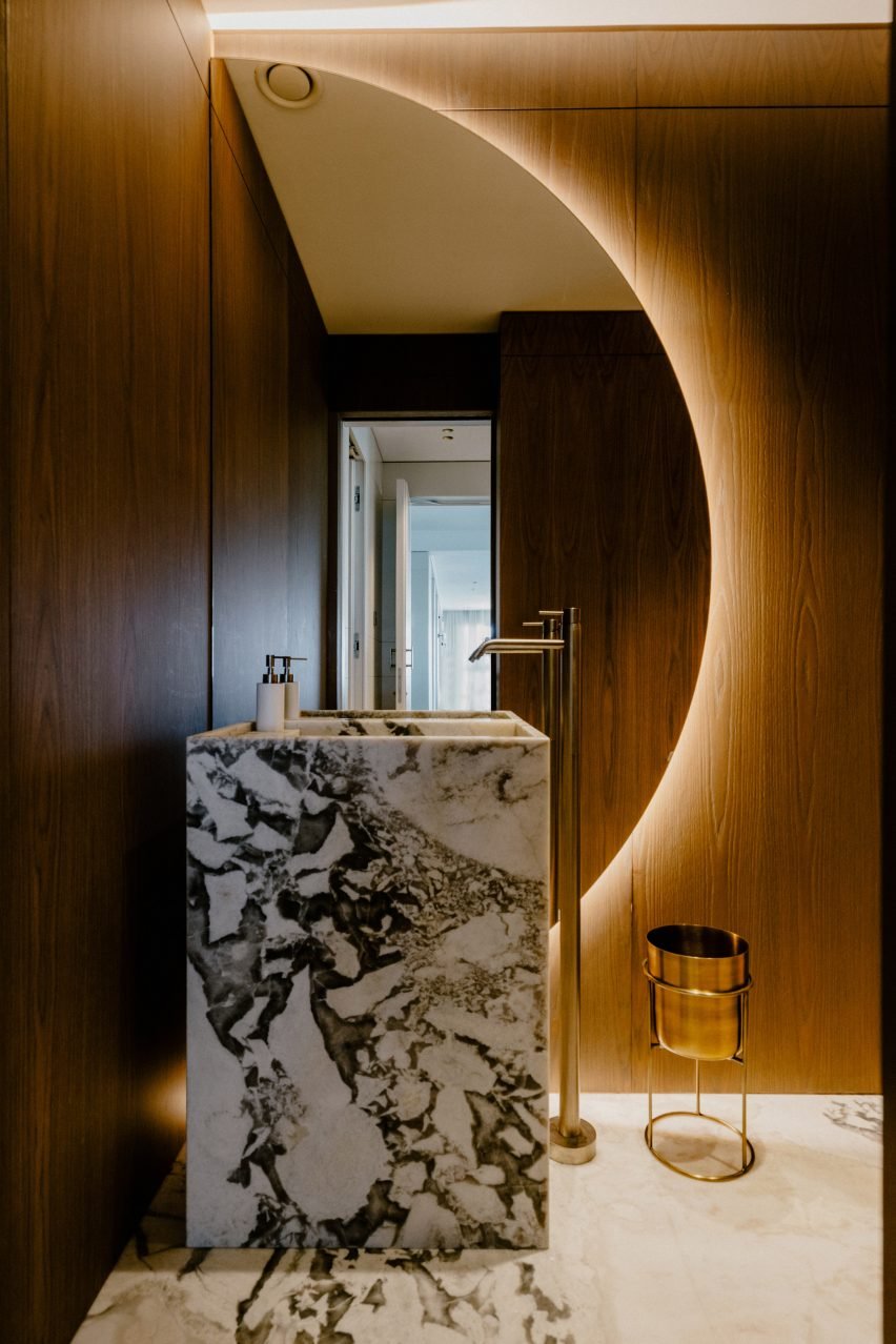 Marble washbasin in bathroom with wood details