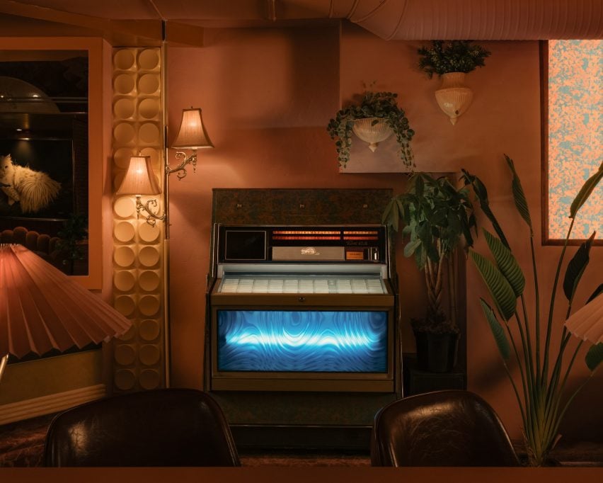 Jukebox with an illuminated blue front within a warm-toned space