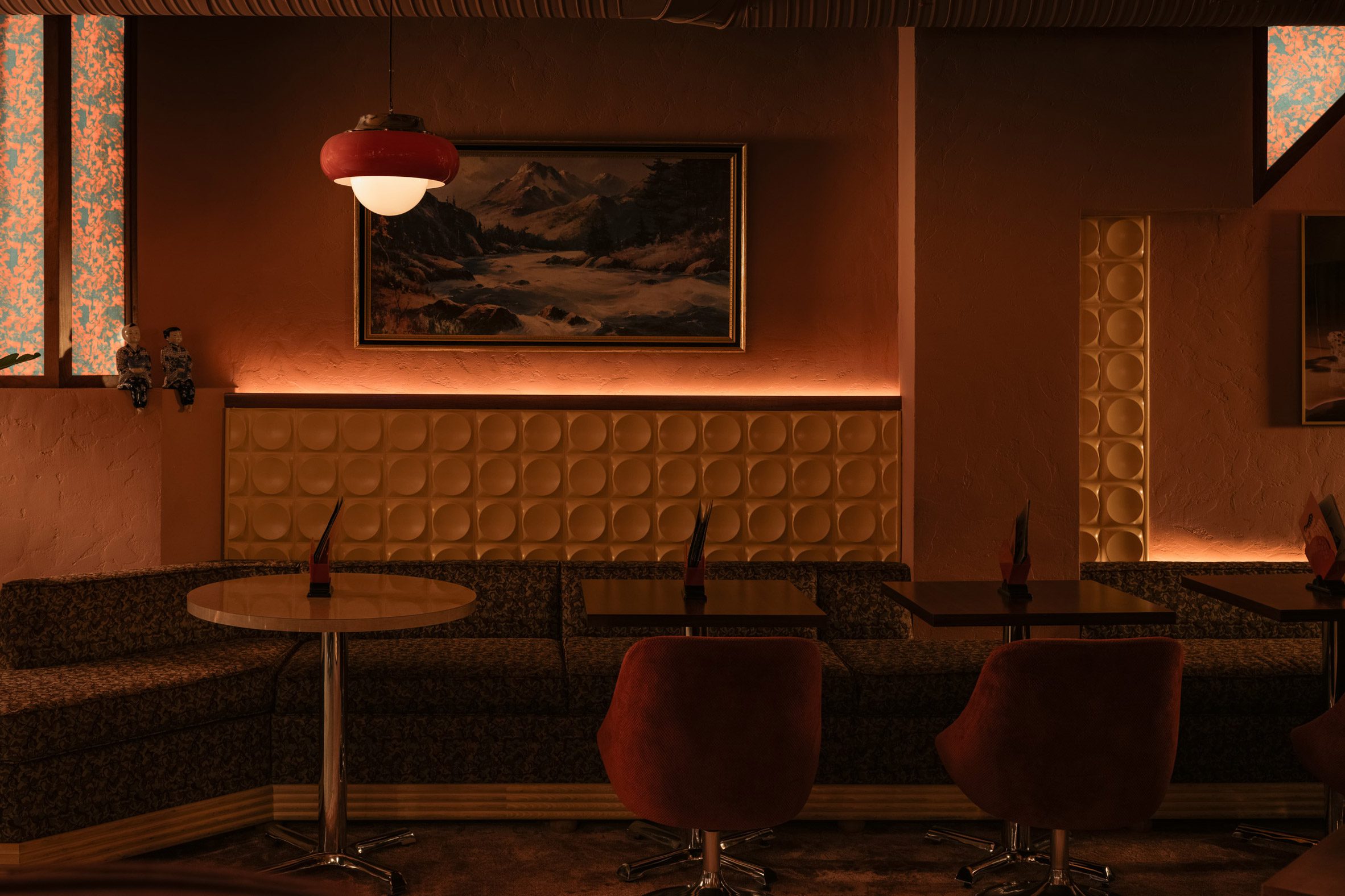 Banquette seating with red pendant light above