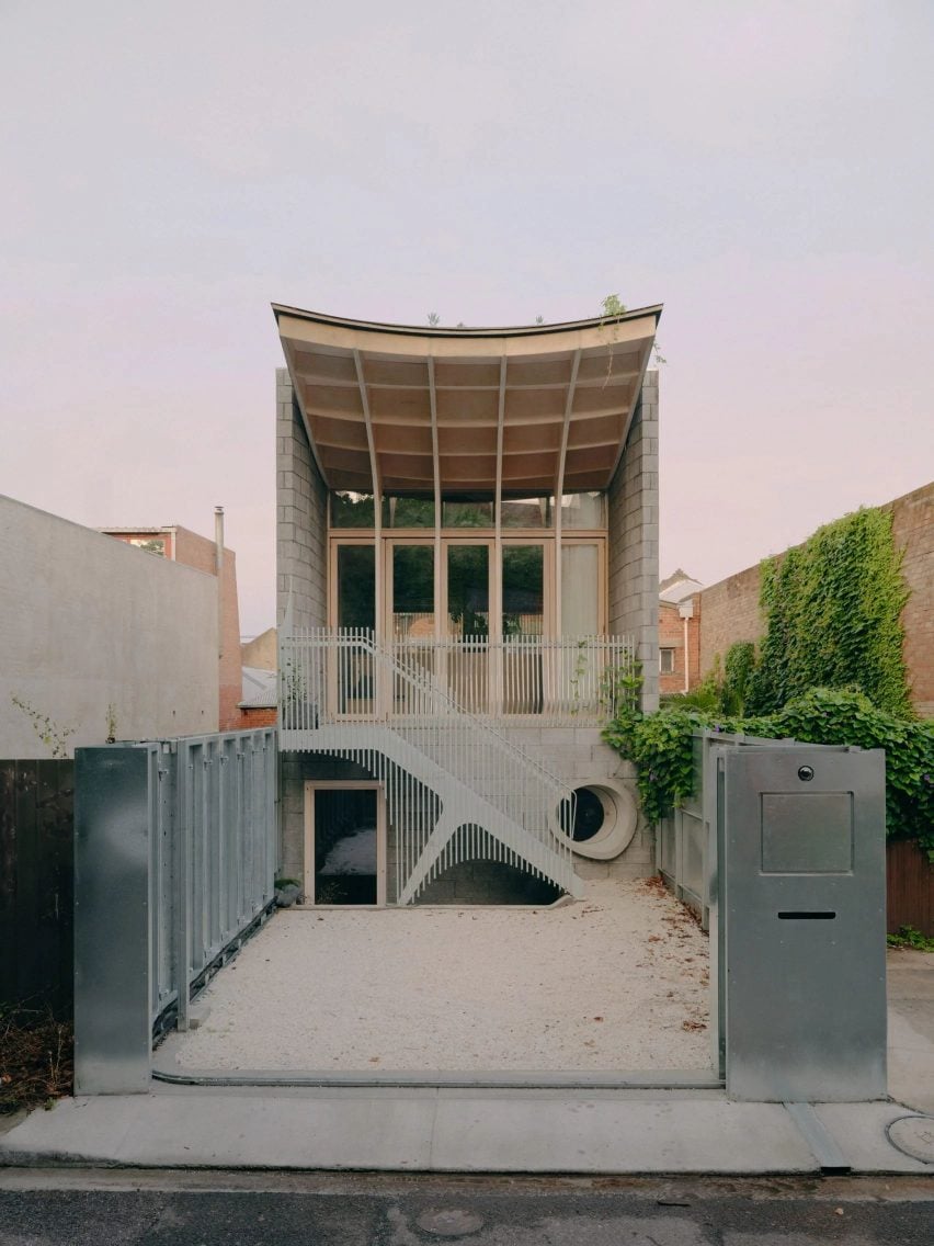 Curved plywood roof house in old parking lot Melbourne