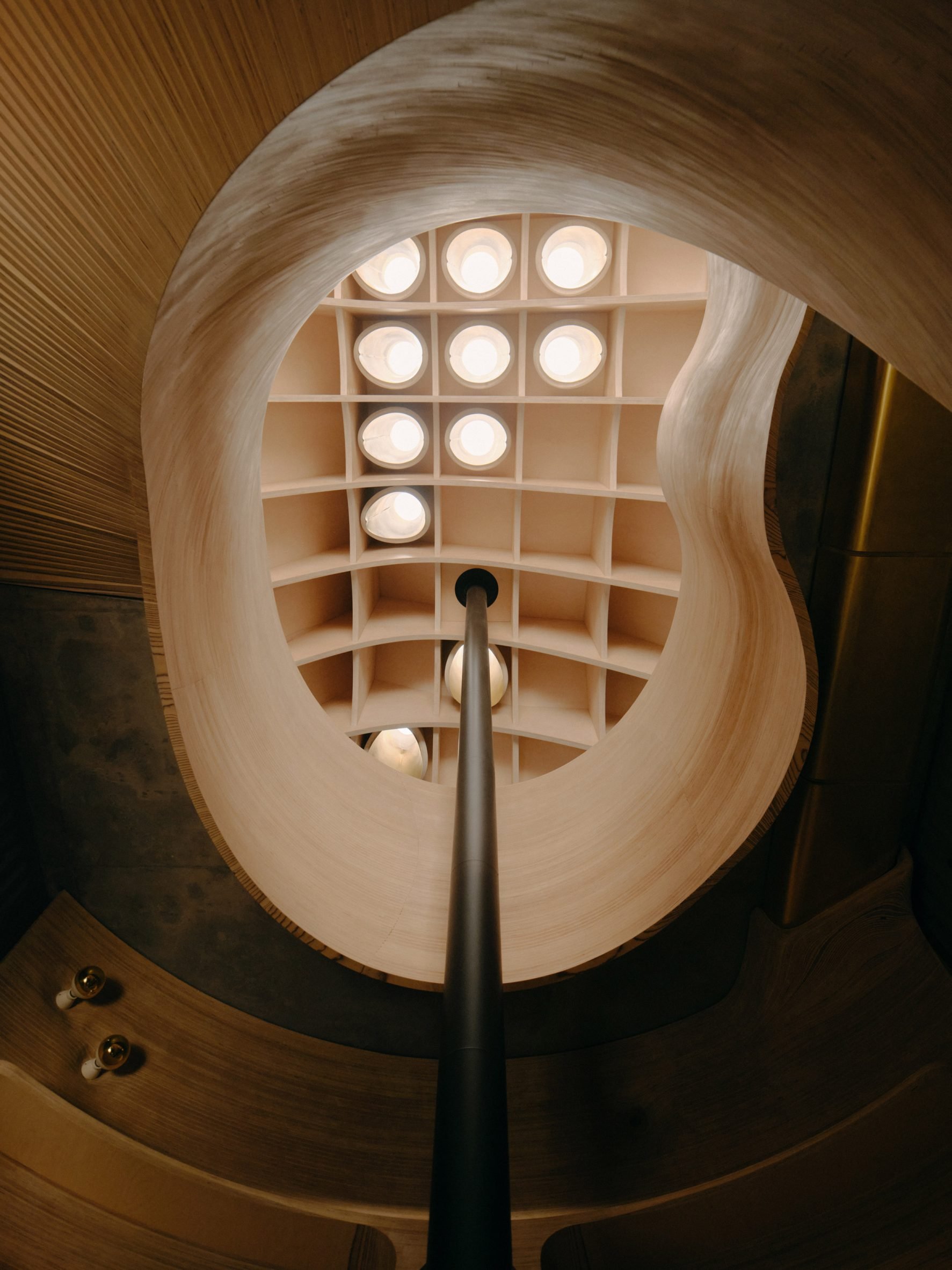 Skylight above a curving plywood staircase