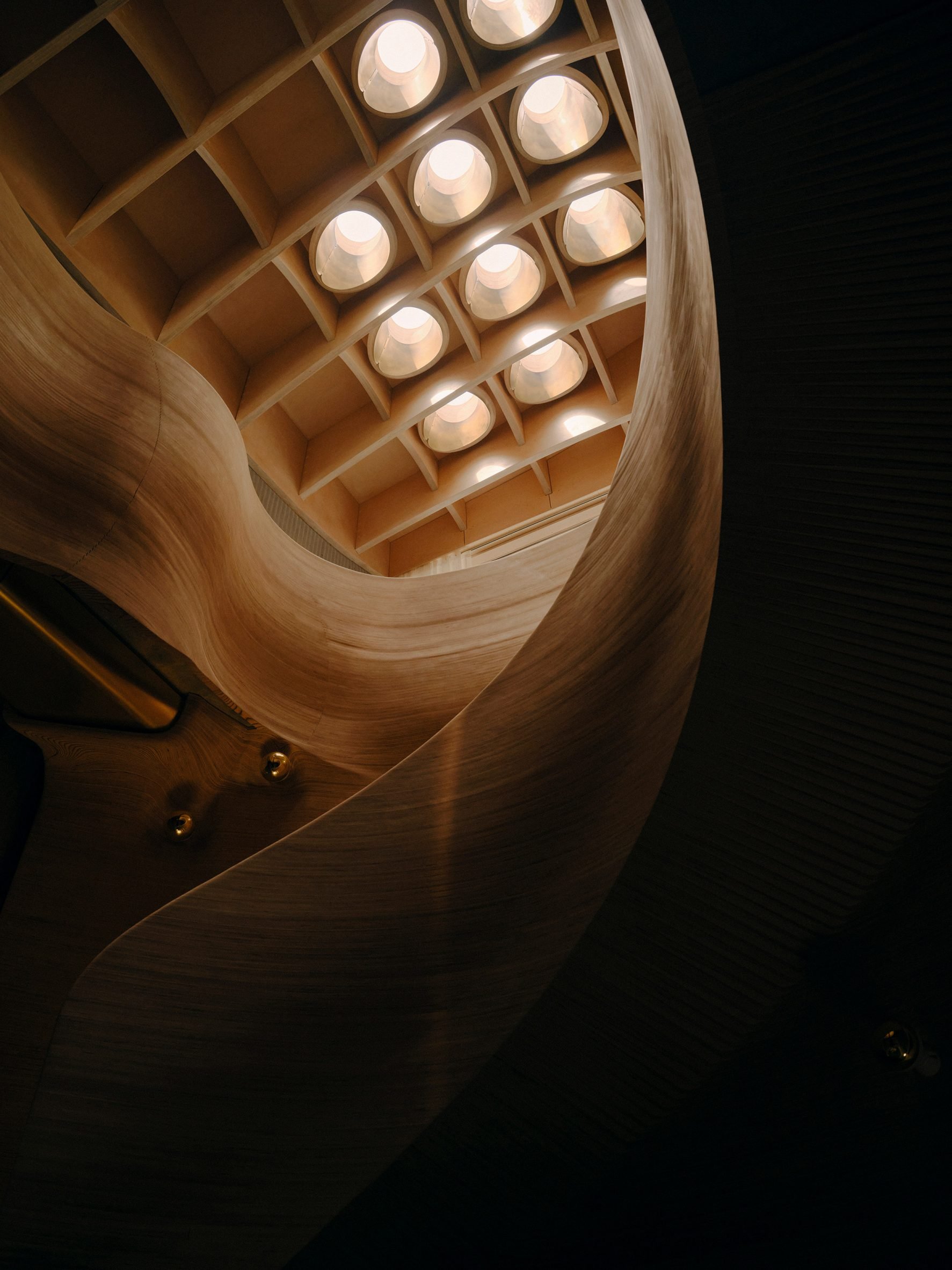 Skylight above a curving plywood staircase