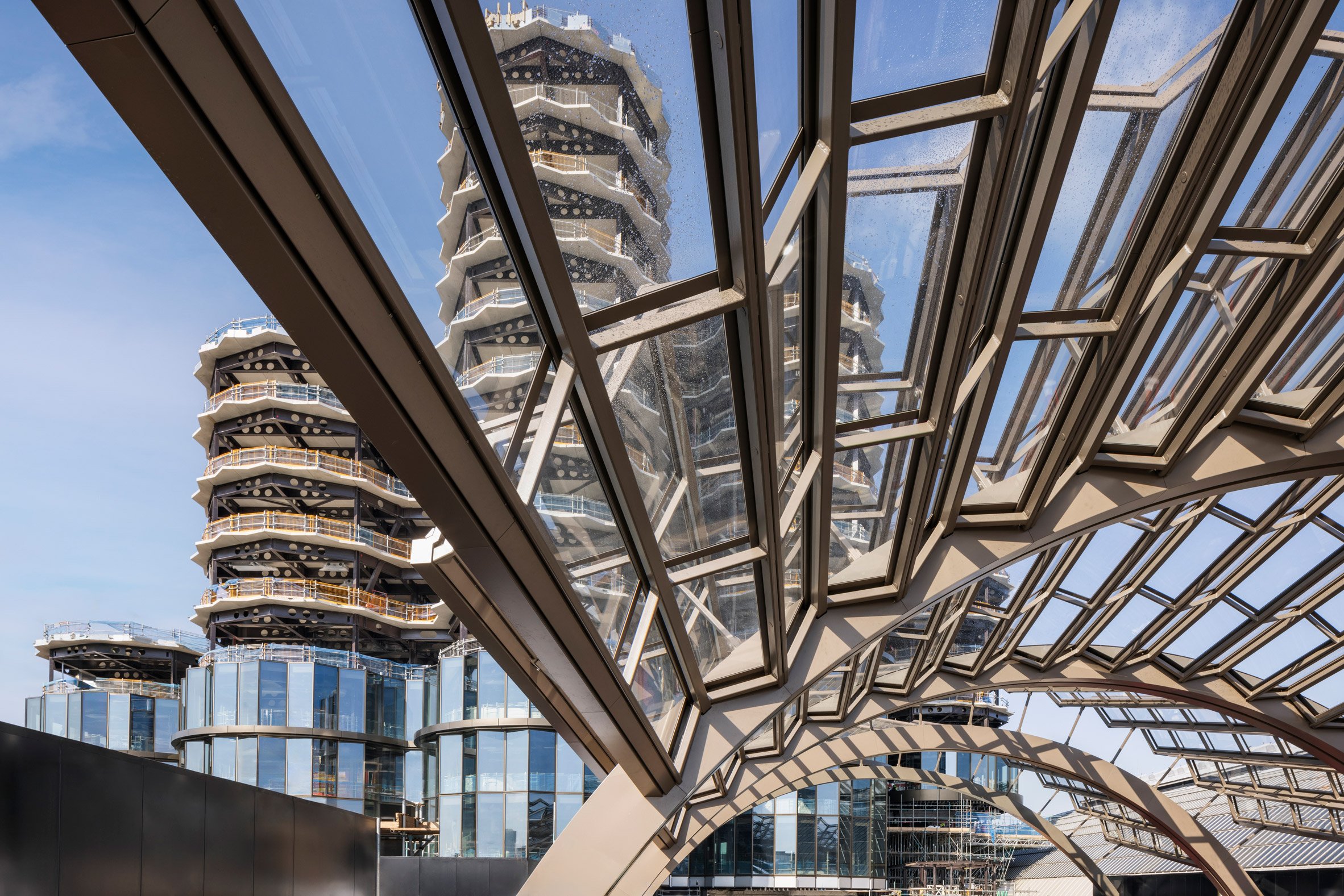 Faceted canopy and office towers at Olympia events centre by Heatherwick Studio and SPPARC