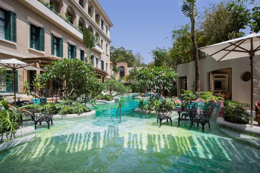 Pool area with blue-green tiles and planting around the perimeter