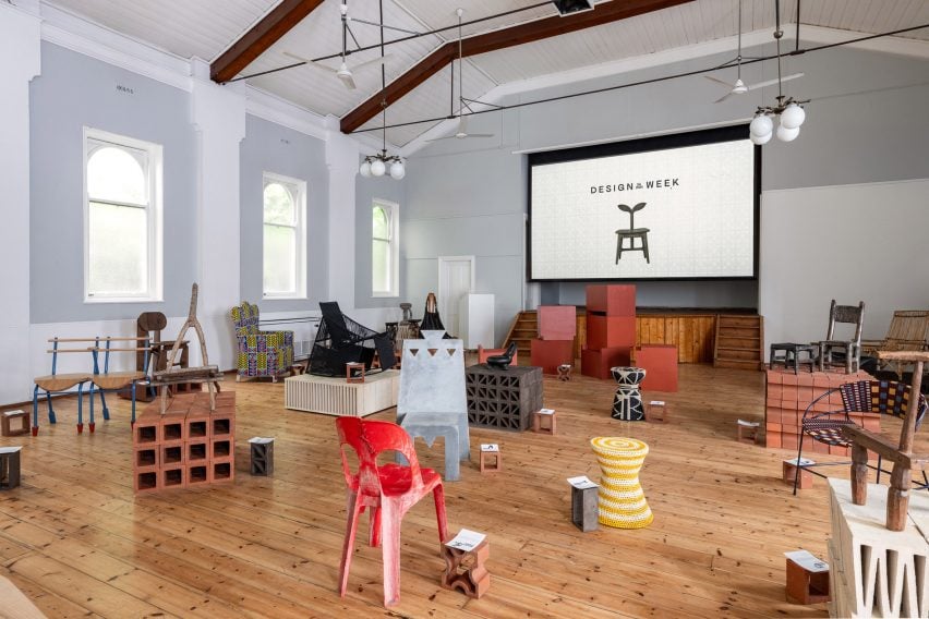 Wide photo of the Africa Chair exhibition at Design Week South Africa 2024 showing many of the chairs in place, some arranged on brick plinths