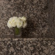 Granite bathroom wall and counter with white flowers