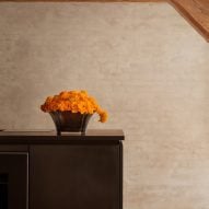 Black kitchen island and orange flowers