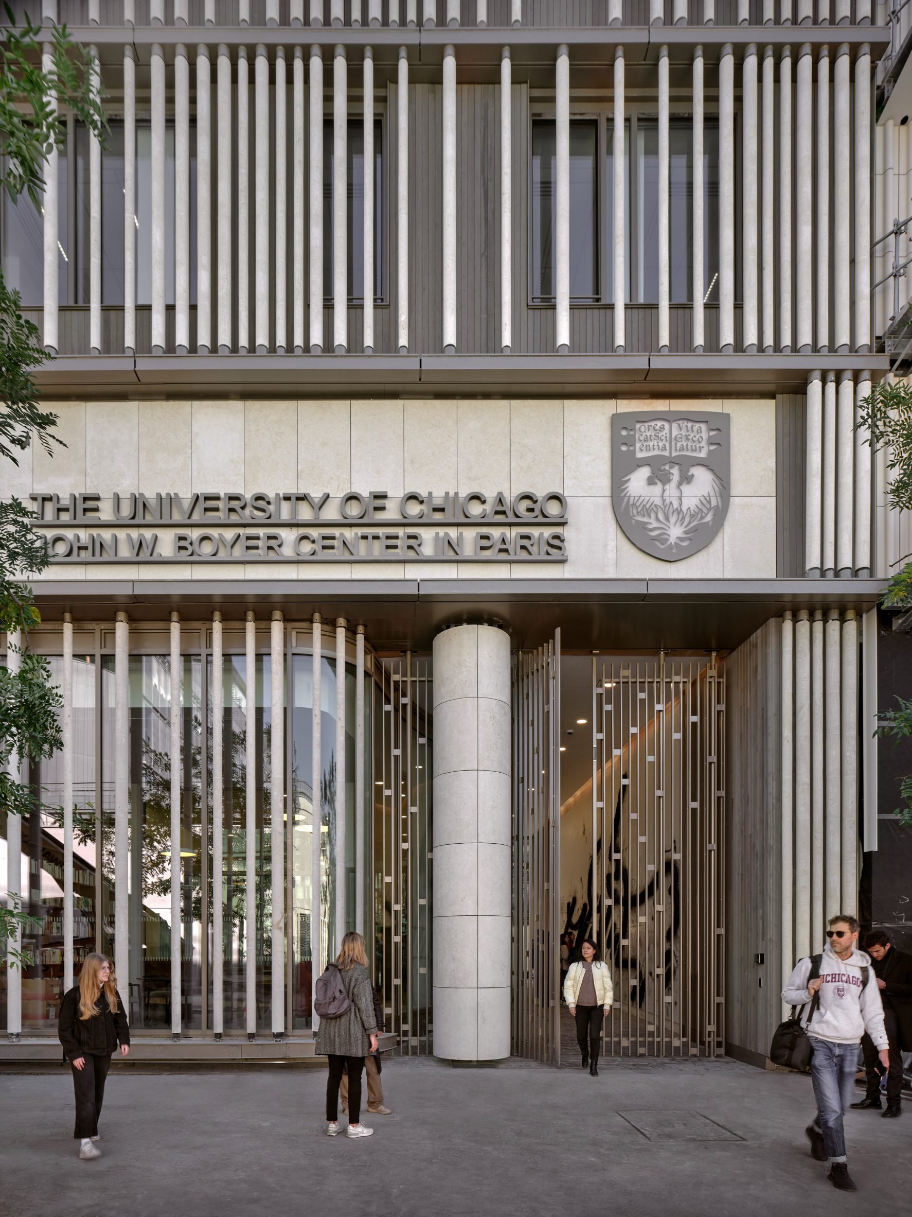 Stone batons on U Chicago research structure in Paris with students outside