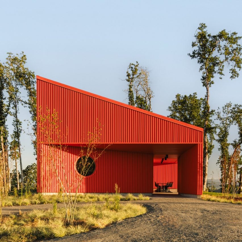 Red corrugated metal building with sloped roof