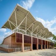 Aidia Studio lofts lightweight metal roof over Mexican grandstand