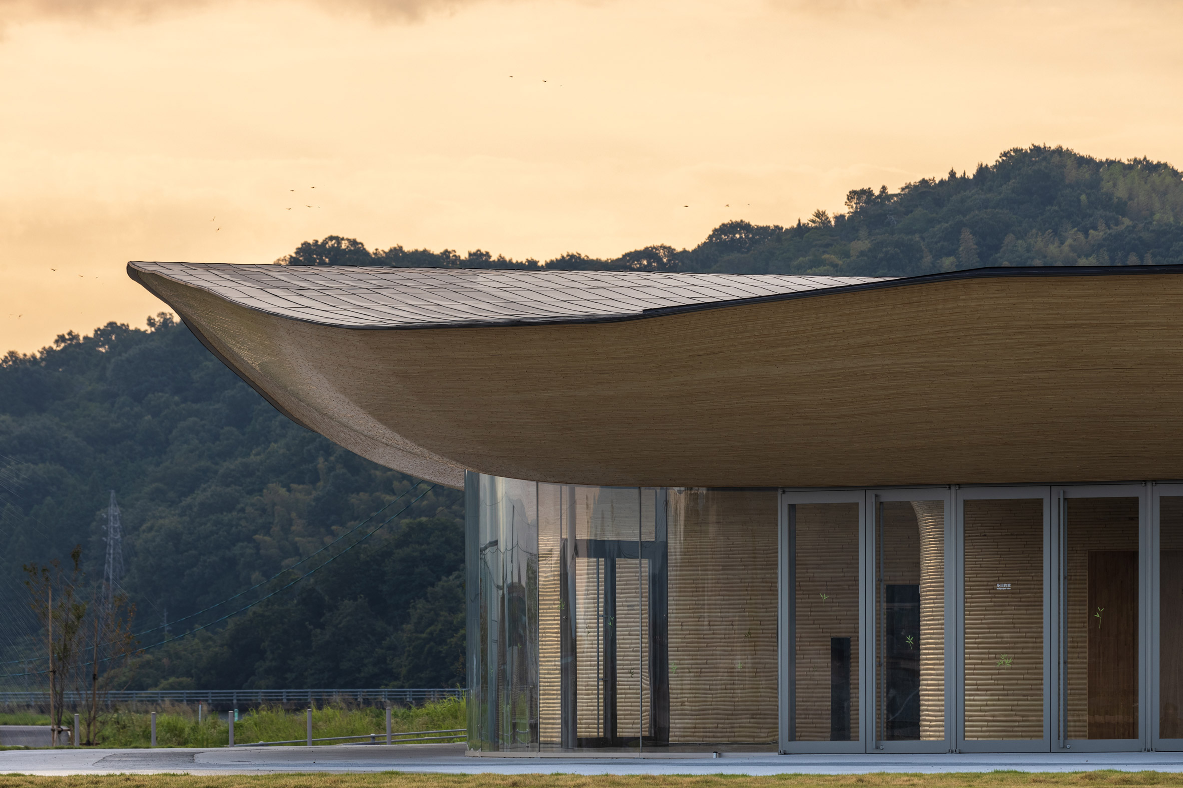 Kengo Kuma tops sculptural community centre with swooping bamboo roof