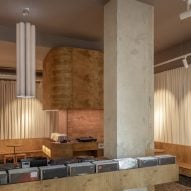 Structural concrete pillars and wooden shelf containing vinyl records