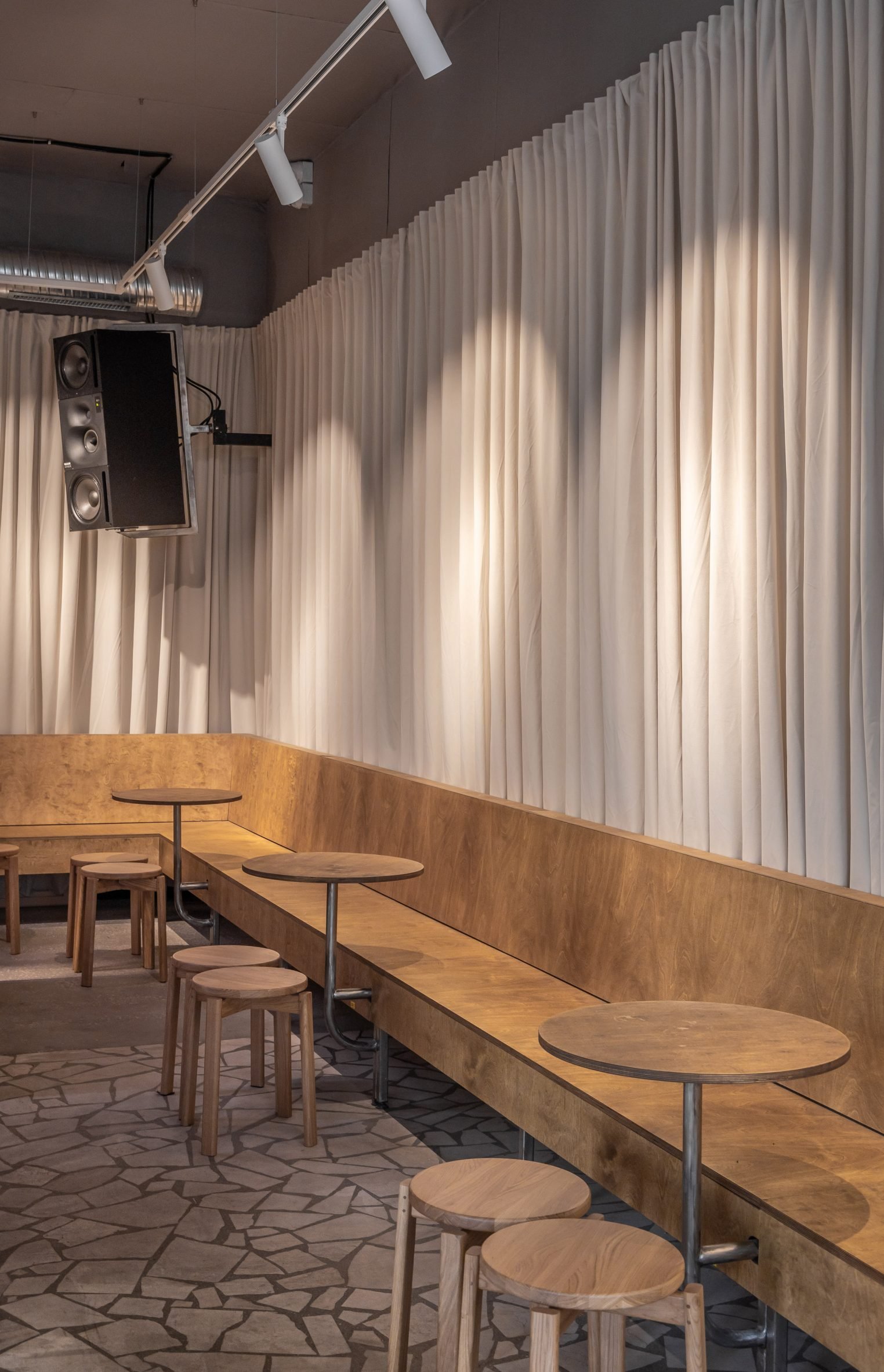 Beige drapes and wooden banquette seating