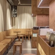 Banquette bench seating and birch plywood wrapped columns containing records