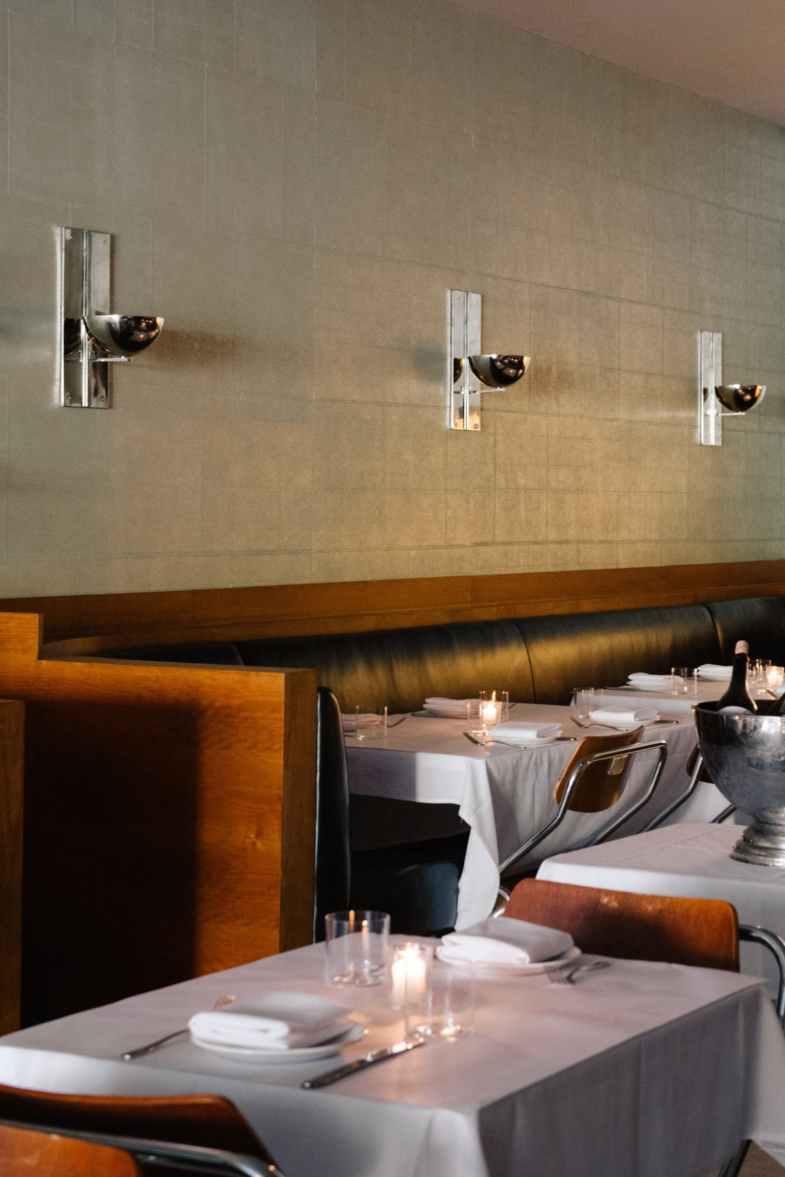 Cherry wood and black leather banquettes in restaurant