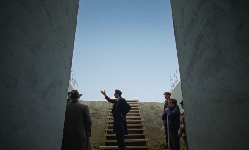 Actors on concrete steps in The Brutalist