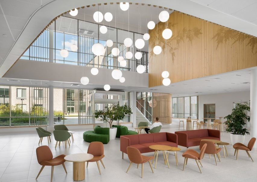 Seating space within healthcare facility by CF Møller Architects