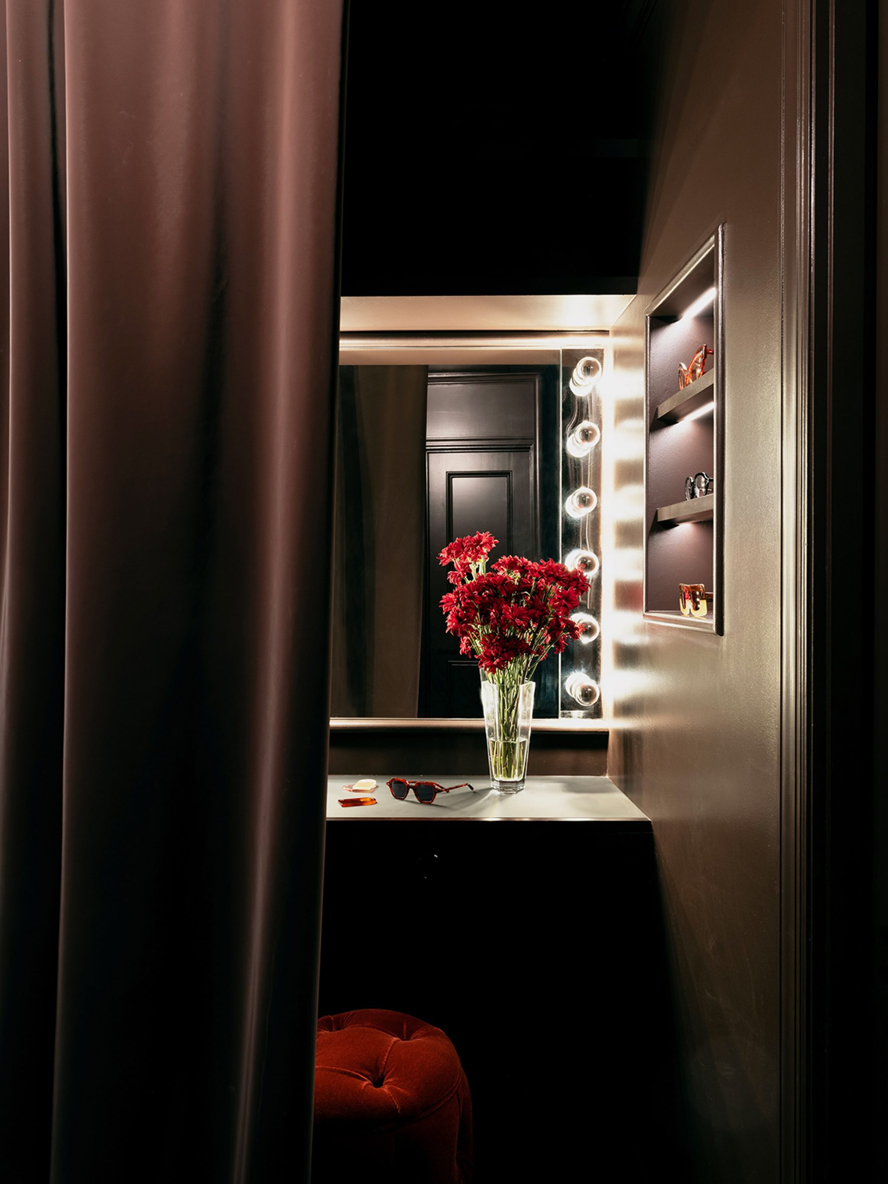 Consultation space decorated dark brown and featuring a vanity mirror