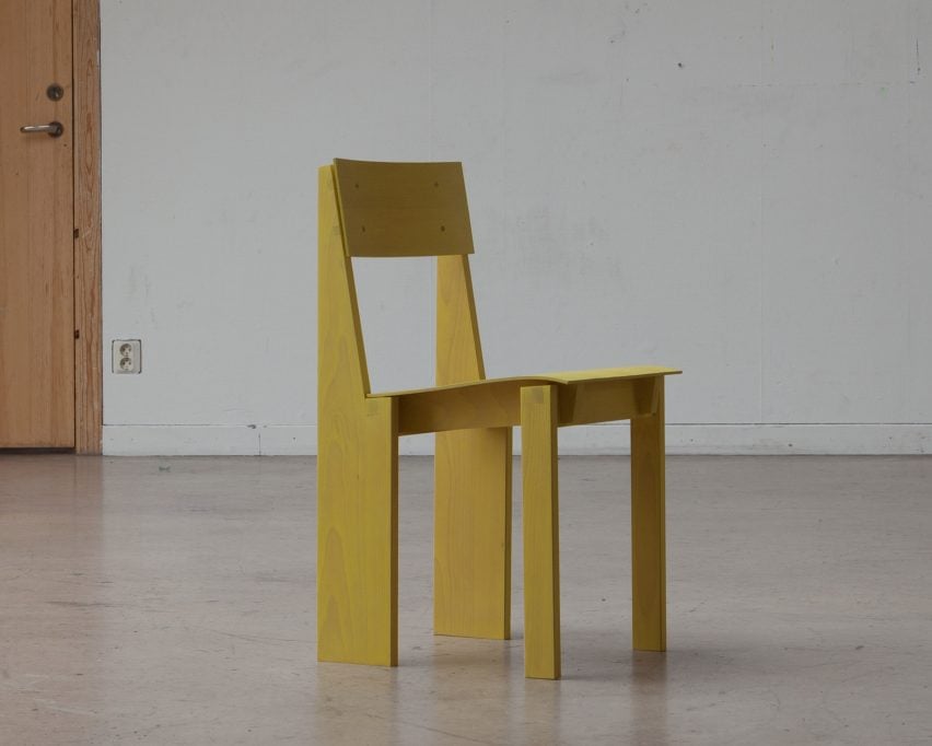 A photograph of a yellow wooden chair.